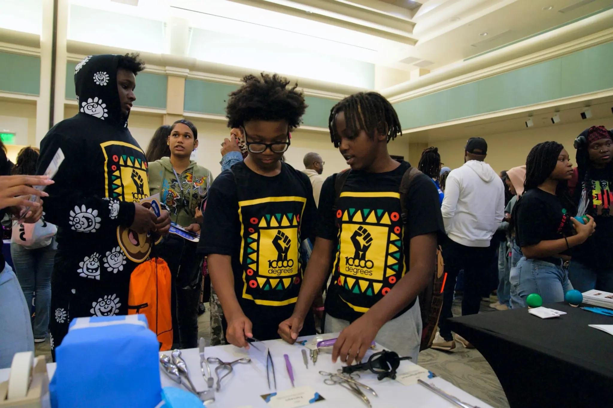 Young people exploring surgical instruments at a hands-on sterile processing demonstration
