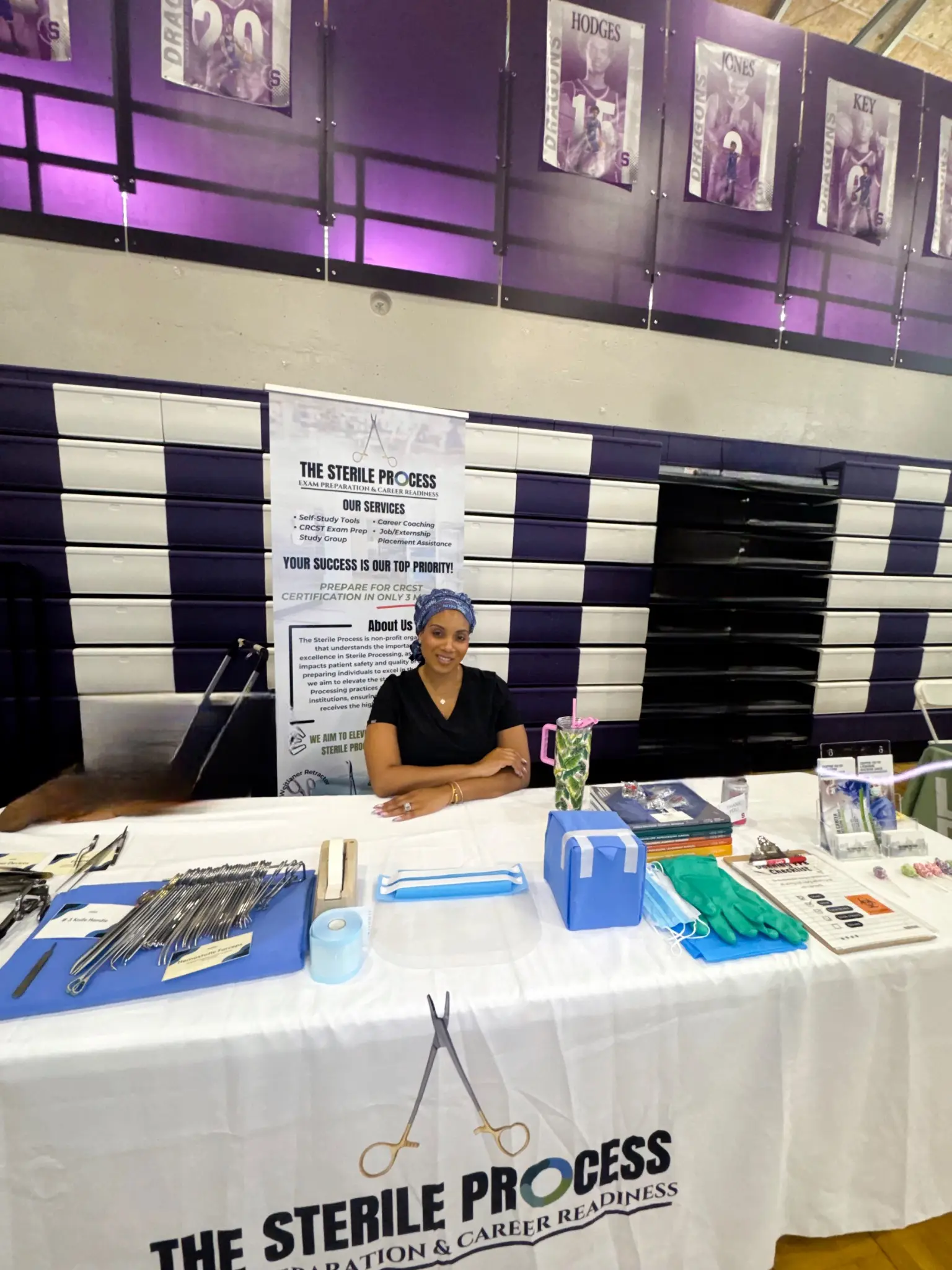 The Sterile Process educator at a community career event with surgical instruments and training materials